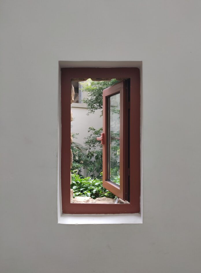 Photo by Richard Wang opened brown wooden framed glass window