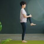 근육 건강, 집에서도 쉽게 챙긴다…일상 속 실천법 인기 Woman practicing yoga on a green mat indoors.