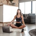 바쁜 일상 속 건강 챙기기, ‘마이크로 운동’으로 시작해보세요 a woman sitting on the floor with a laptop