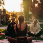 “여성 건강관리, 일상의 작은 변화에서 시작하세요” a group of people sitting on top of a lush green field