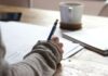 일상에서 실천하는 웰니스 문화, 작은 변화가 건강을 부른다 person writing on brown wooden table near white ceramic mug